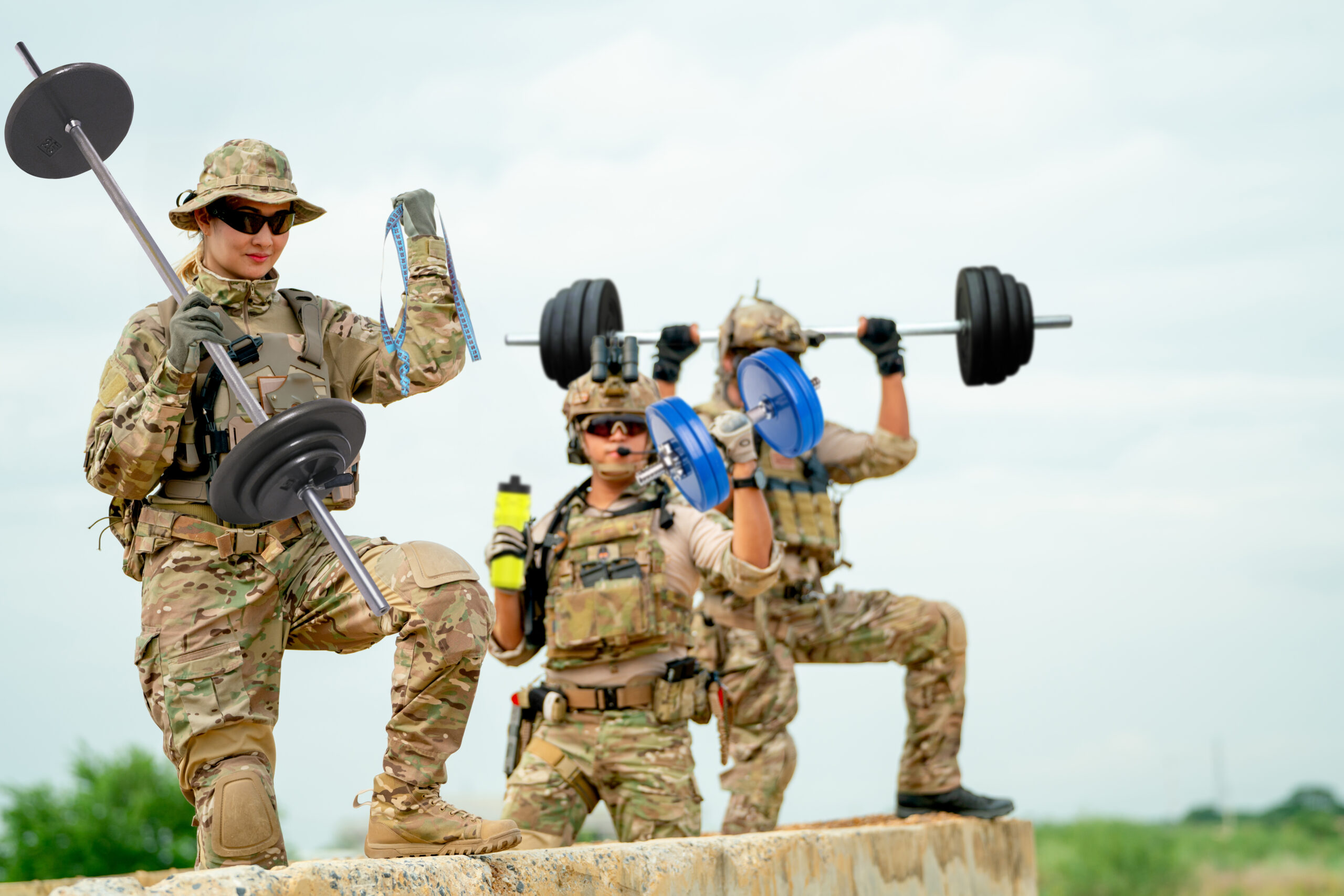 Soldiers in tactical gear lifting weights, symbolizing the choice between solo and team-based workouts.